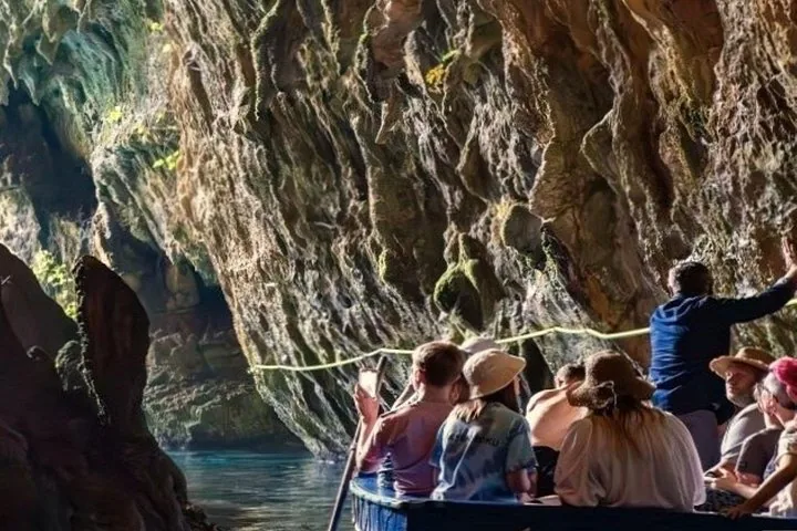 Group of tourists enjoying a boat ride in Melissani Cave.